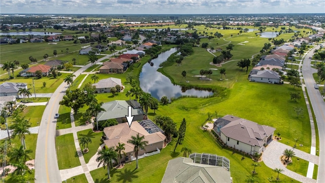 birds eye view of property with a water view and a residential view