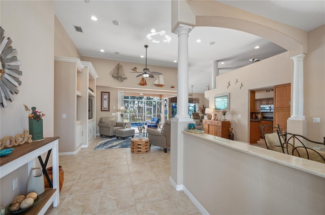 corridor with arched walkways, visible vents, decorative columns, and recessed lighting