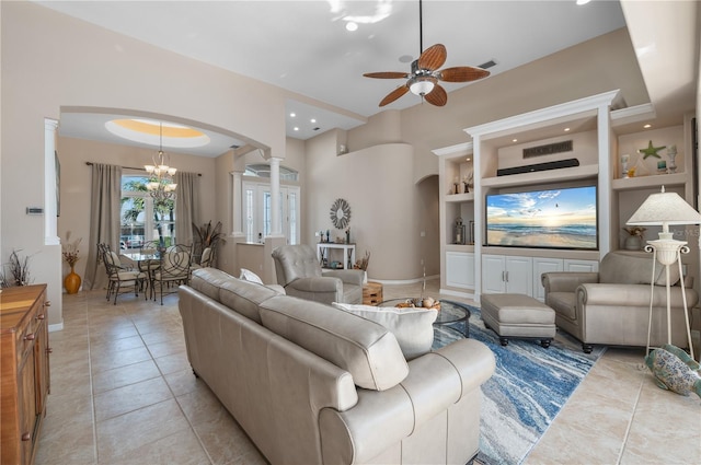 living area with arched walkways, built in shelves, light tile patterned flooring, visible vents, and decorative columns