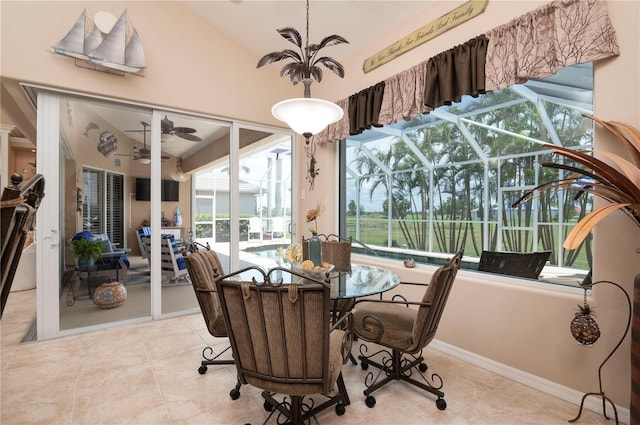 dining space with ceiling fan, tile patterned flooring, and a sunroom