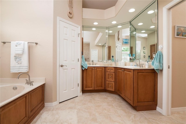 bathroom featuring recessed lighting, double vanity, a sink, and a bath