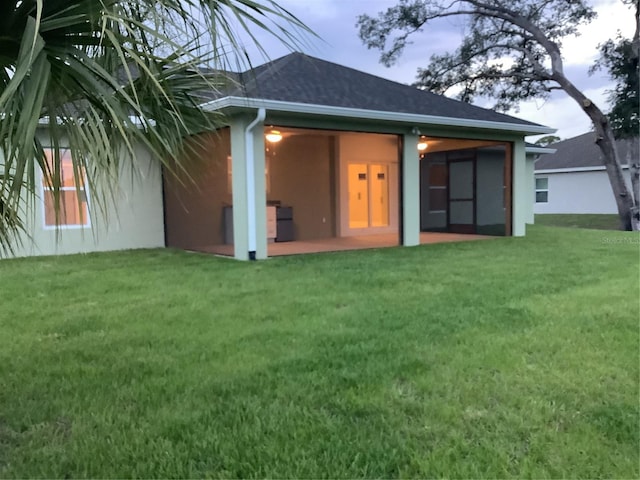 back of property with a lawn