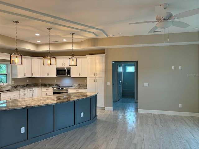 kitchen with white cabinetry, hanging light fixtures, stainless steel appliances, and dark stone countertops