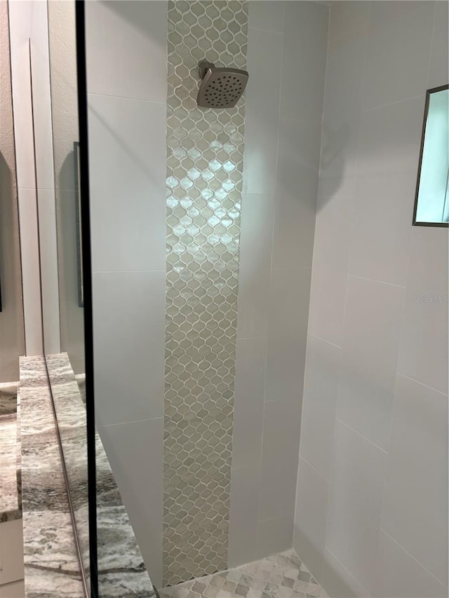 bathroom with a tile shower