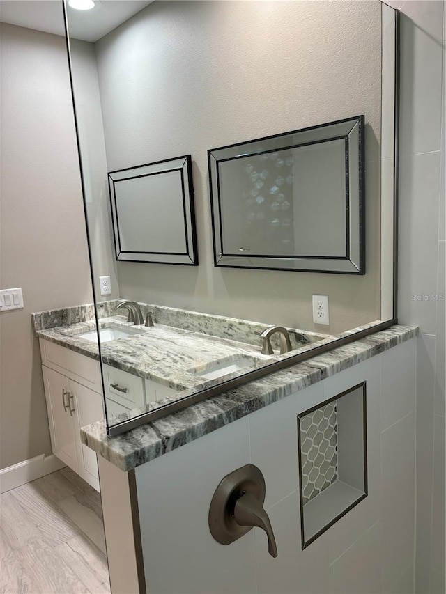 bathroom with vanity and hardwood / wood-style flooring