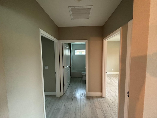 hallway with light wood-type flooring