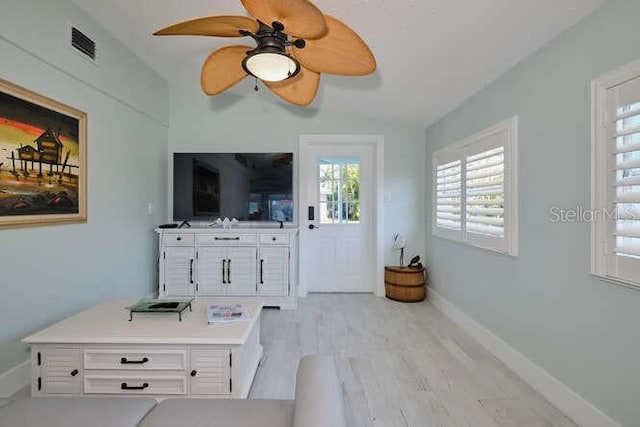 living room featuring ceiling fan and light wood-type flooring