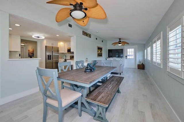 dining space with light wood-type flooring, a wealth of natural light, and ceiling fan