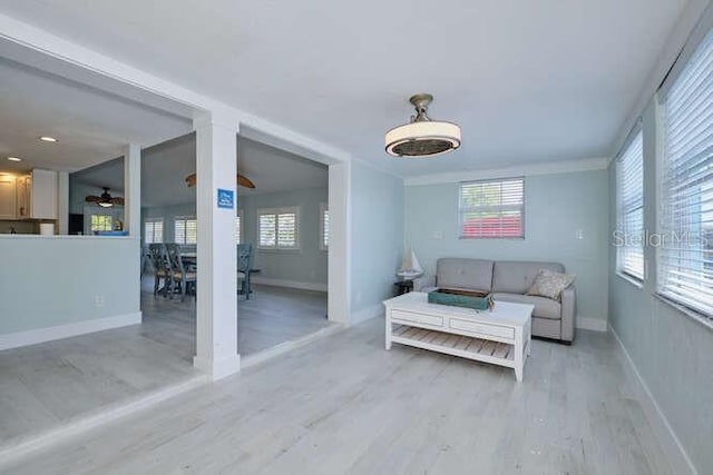 living room with ceiling fan and light hardwood / wood-style flooring