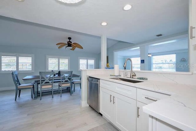 kitchen featuring dishwasher, sink, ceiling fan, light wood-type flooring, and white cabinetry