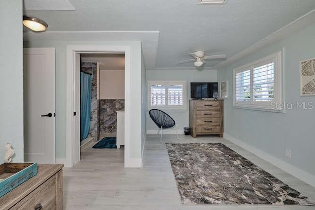 bedroom featuring multiple windows, ceiling fan, and light hardwood / wood-style flooring