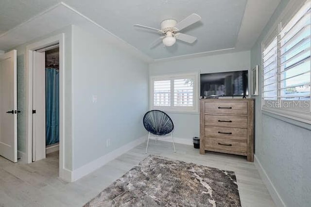 living area featuring ceiling fan and light wood-type flooring