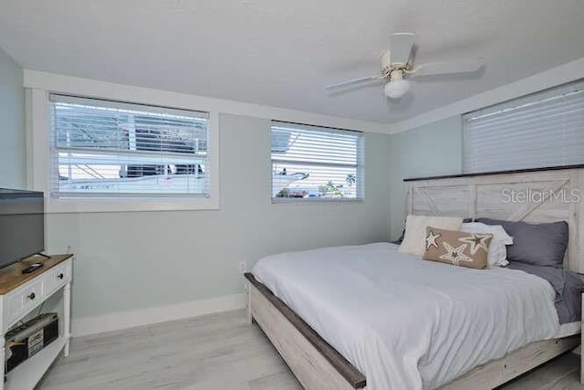 bedroom featuring ceiling fan and light hardwood / wood-style flooring