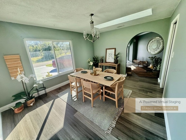 dining area featuring a chandelier, a textured ceiling, and dark hardwood / wood-style flooring