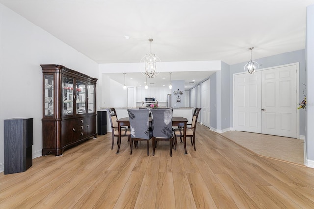 dining room featuring light hardwood / wood-style floors and a chandelier