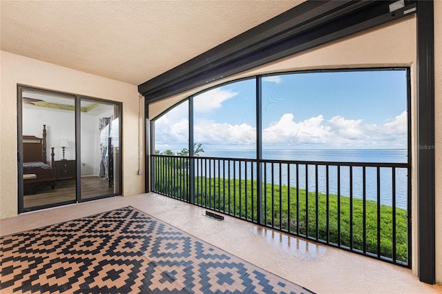 sunroom featuring a water view and plenty of natural light