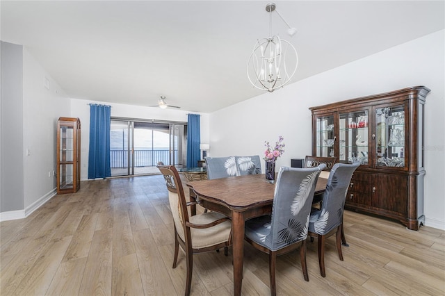 dining room featuring ceiling fan with notable chandelier and light wood-type flooring