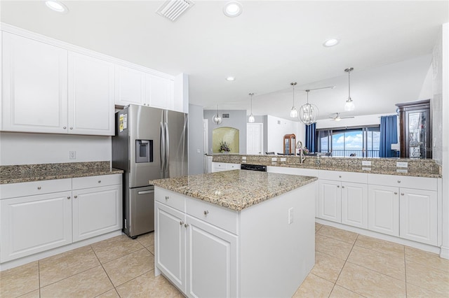 kitchen featuring white cabinetry, kitchen peninsula, stainless steel fridge, decorative light fixtures, and a kitchen island