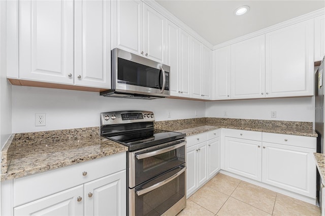 kitchen with light tile patterned floors, white cabinetry, and appliances with stainless steel finishes