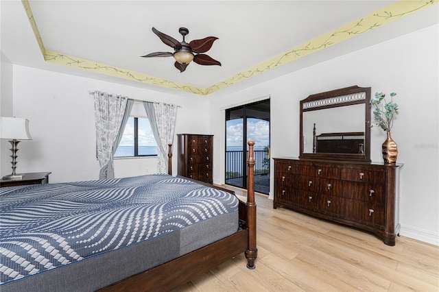 bedroom with ceiling fan, light hardwood / wood-style floors, and access to outside