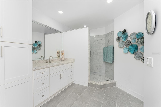 bathroom with tile patterned floors, vanity, and tiled shower