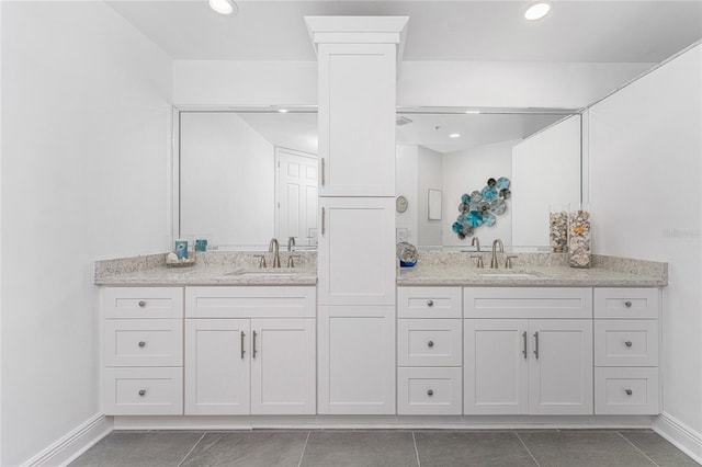 bathroom with tile patterned flooring and vanity