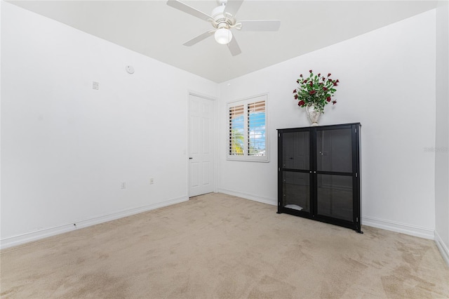 empty room with light carpet and ceiling fan