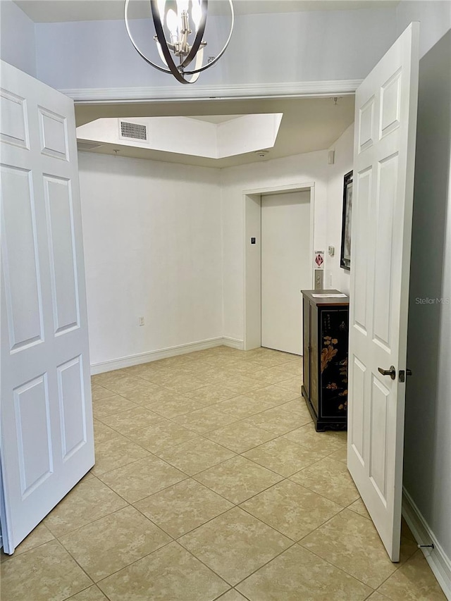 spare room with baseboards, a chandelier, light tile patterned flooring, visible vents, and elevator
