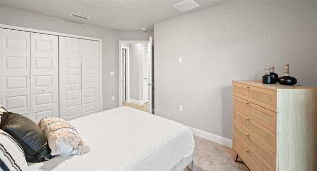 bedroom with a closet and light colored carpet