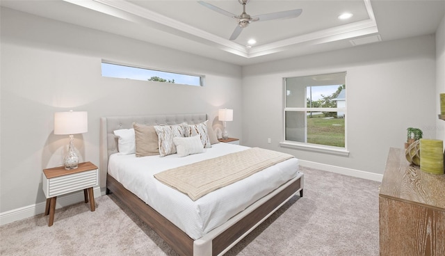 carpeted bedroom featuring a raised ceiling, multiple windows, crown molding, and ceiling fan