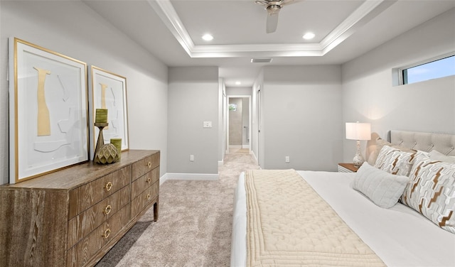 bedroom featuring a raised ceiling, ceiling fan, light colored carpet, and ornamental molding