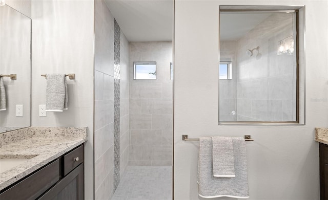 bathroom featuring vanity and tiled shower