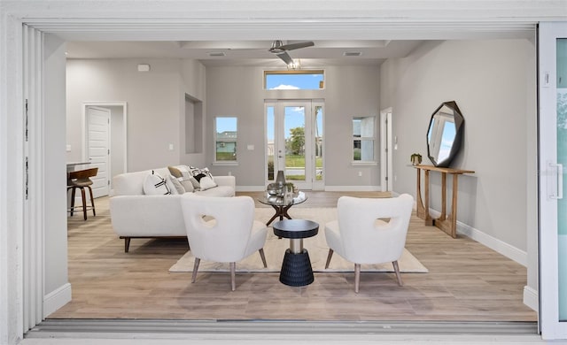 living room featuring ceiling fan and light wood-type flooring