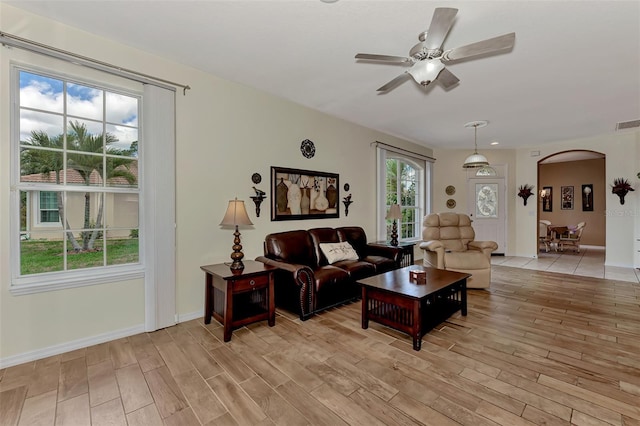 living room featuring ceiling fan and light wood-type flooring