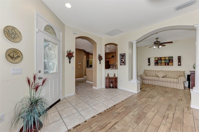 entrance foyer featuring ceiling fan and ornate columns