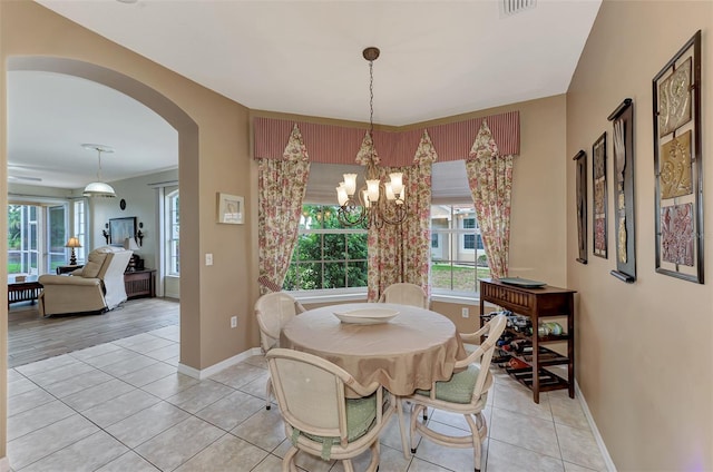 dining room with light tile patterned floors and a notable chandelier