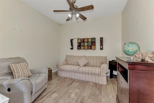 living room featuring ceiling fan and light wood-type flooring