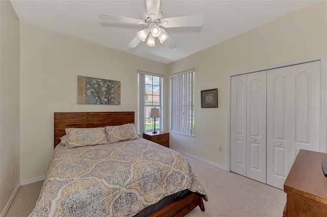 carpeted bedroom featuring a closet and ceiling fan