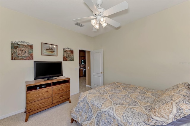 bedroom featuring ceiling fan and light carpet