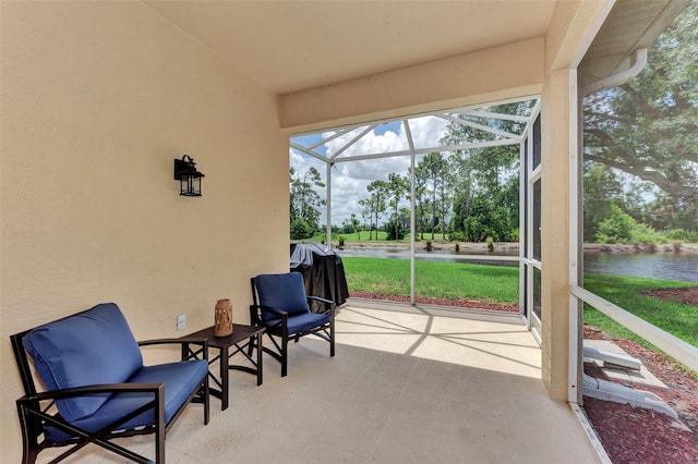 sunroom / solarium with a water view