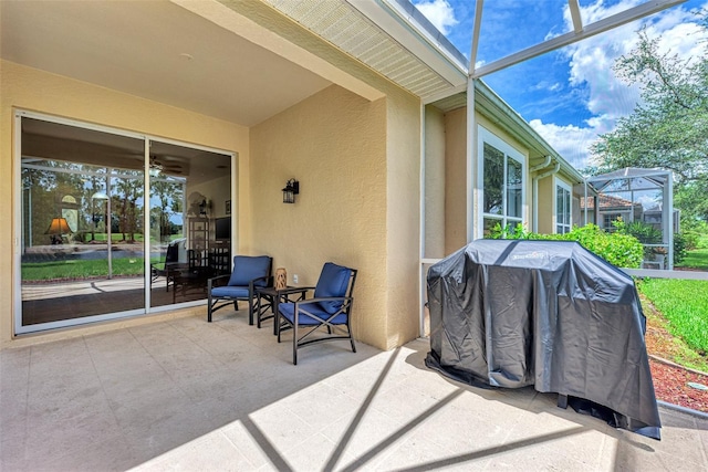 view of patio / terrace with area for grilling and glass enclosure