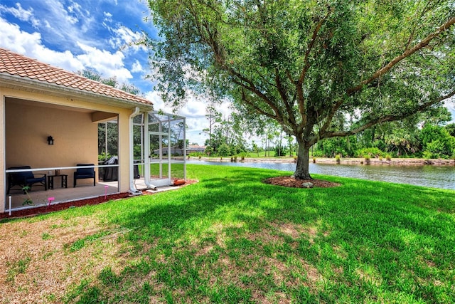 view of yard with a water view and a patio area