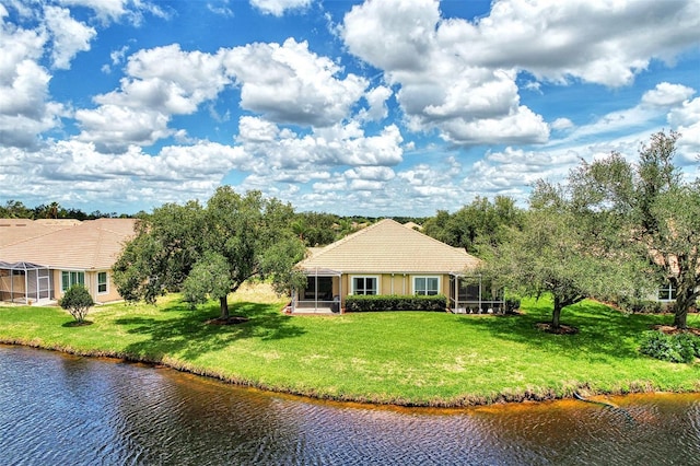 exterior space featuring a water view, a lanai, and a front yard