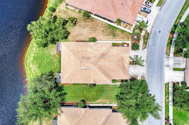 birds eye view of property with a water view