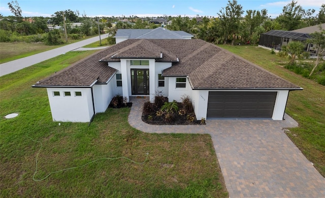 view of front of property featuring a garage and a front yard