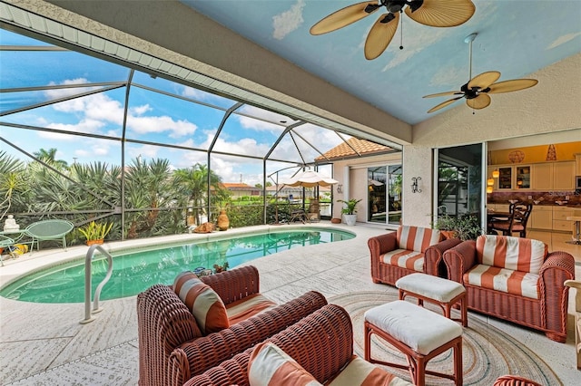 view of swimming pool featuring ceiling fan, a patio area, an outdoor hangout area, and glass enclosure