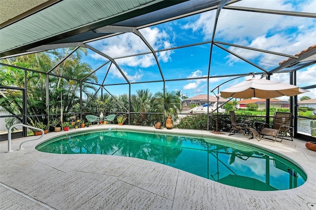 view of pool with a patio area and a lanai