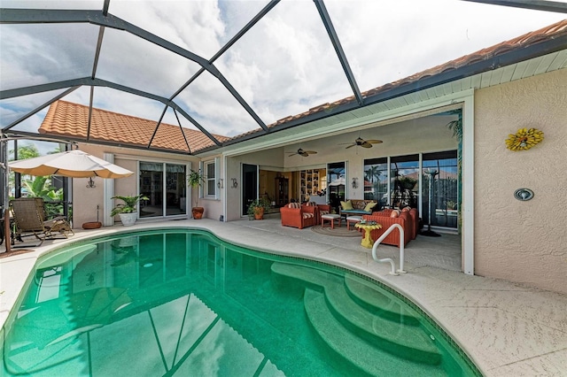 view of pool featuring ceiling fan, a patio area, an outdoor living space, and glass enclosure