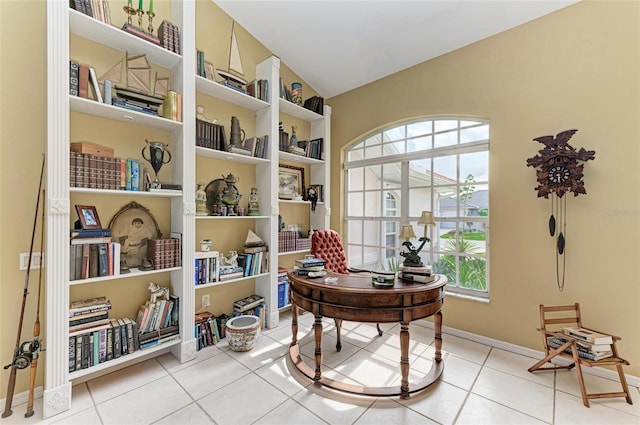 tiled home office featuring lofted ceiling and a healthy amount of sunlight