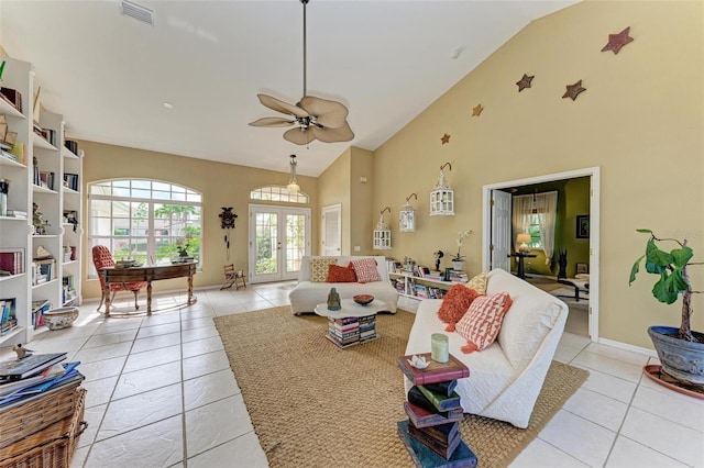 living room with ceiling fan, french doors, light tile patterned floors, and vaulted ceiling